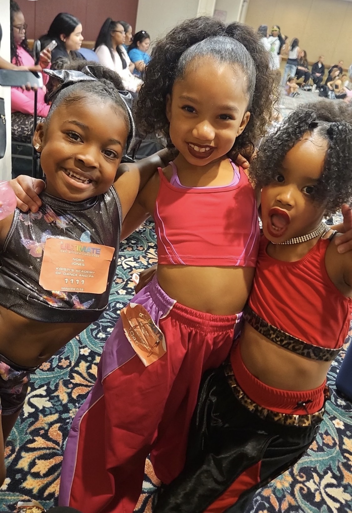 Tiny and Mini K Company dancers hugging and having fun at competition